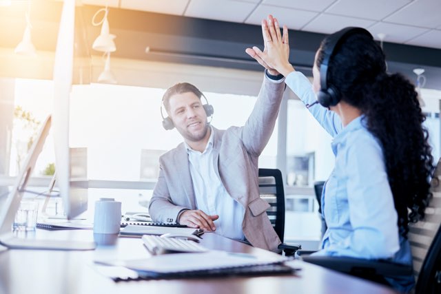 Business people, call center and high five for winning, teamwork or success in customer service at the office. Employee consultants touching hands in celebration for team win, bonus or promotion
