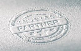 3D illustration of an embossed stamp with the text trusted partner, Paper background and blur effect. Concept of confidence in business relationship.