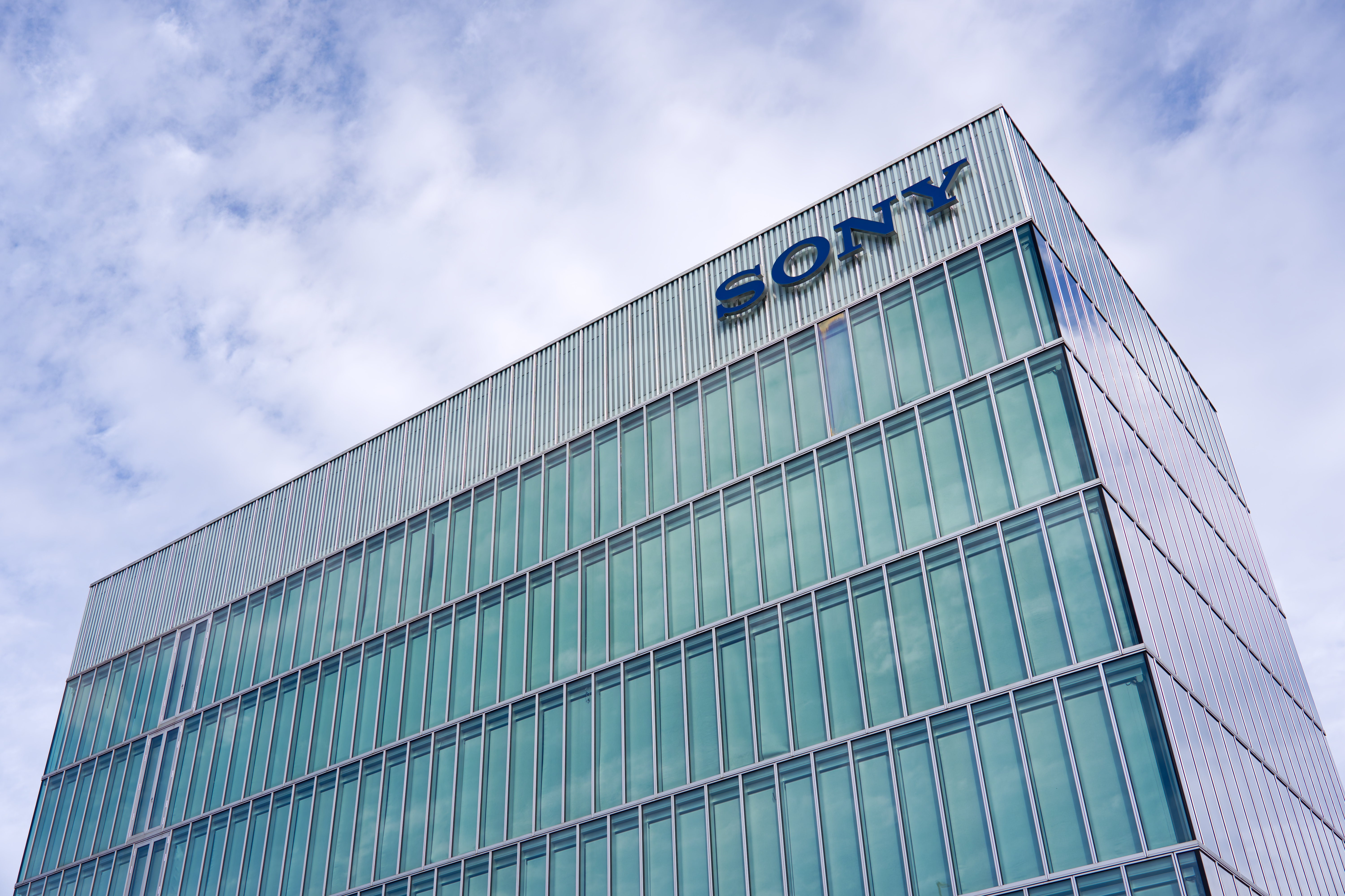 Looking up glass facade of office tower of Sony headquarters of Switzerland at Swiss city of Schlieren on a cloudy late summer afternoon. Photo taken September 16th, 2025, Schlieren, Switzerland.